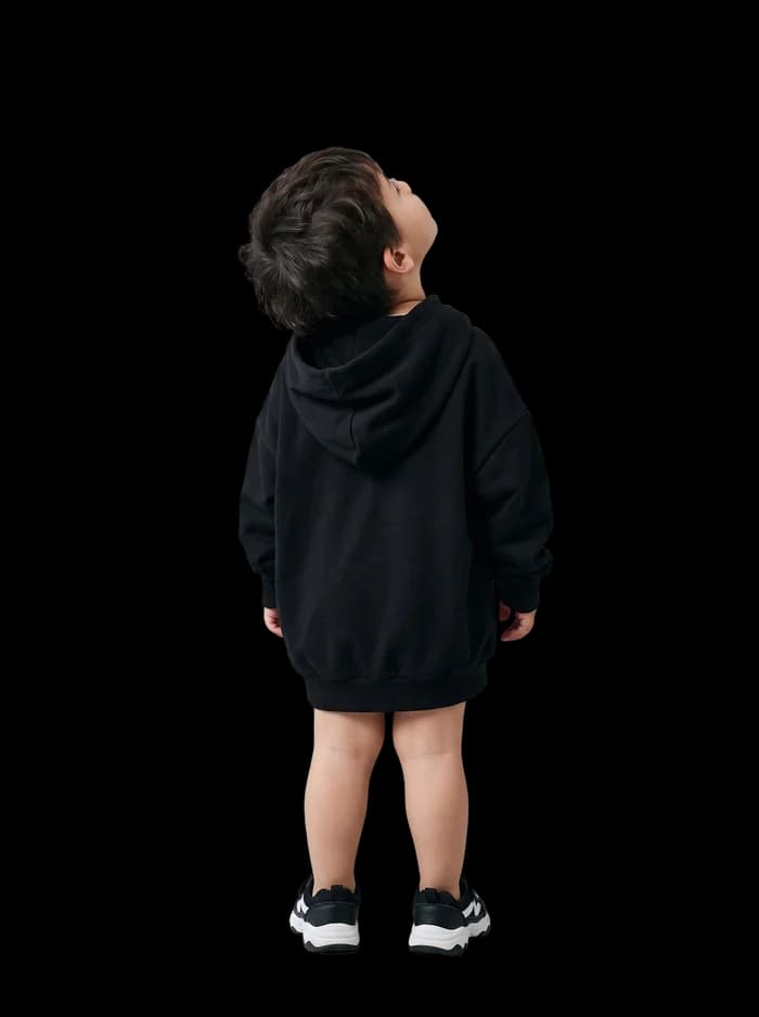 A small boy looking up at the frame from the gallery floor